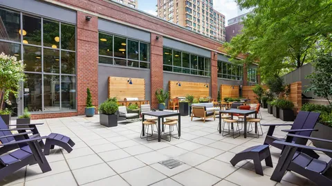 a view of a patio with table and chairs and potted plants