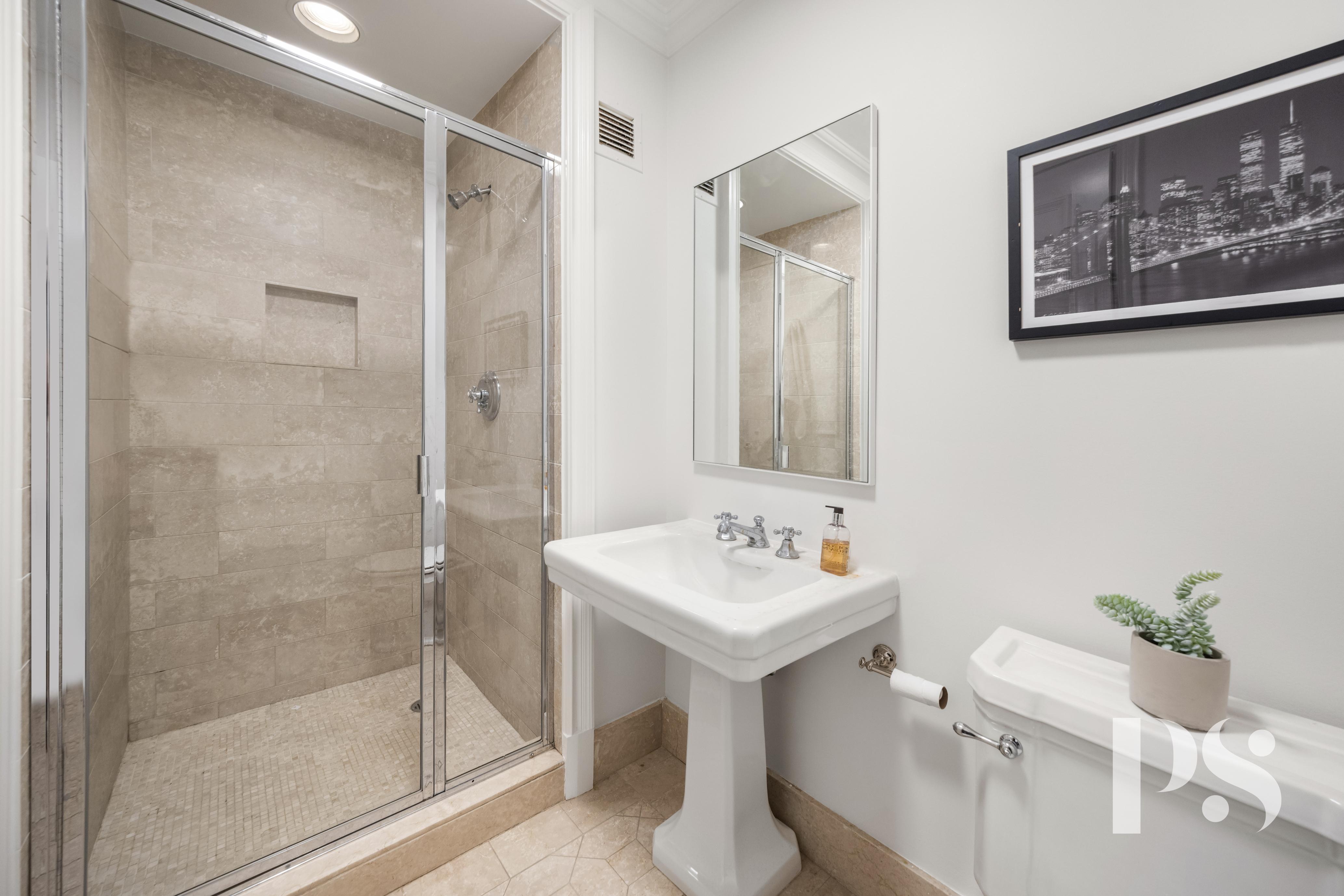 610 Park Avenue, Unit 4B Manhattan, NY 10065 - Photo 19 of 22 a bathroom with a sink mirror and a shower
