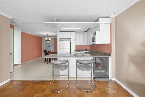 a kitchen with stainless steel appliances kitchen island granite countertop a sink and cabinets