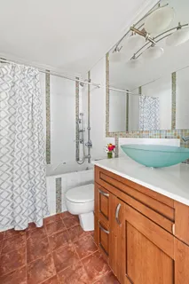 a bathroom with a sink a toilet and shower curtain