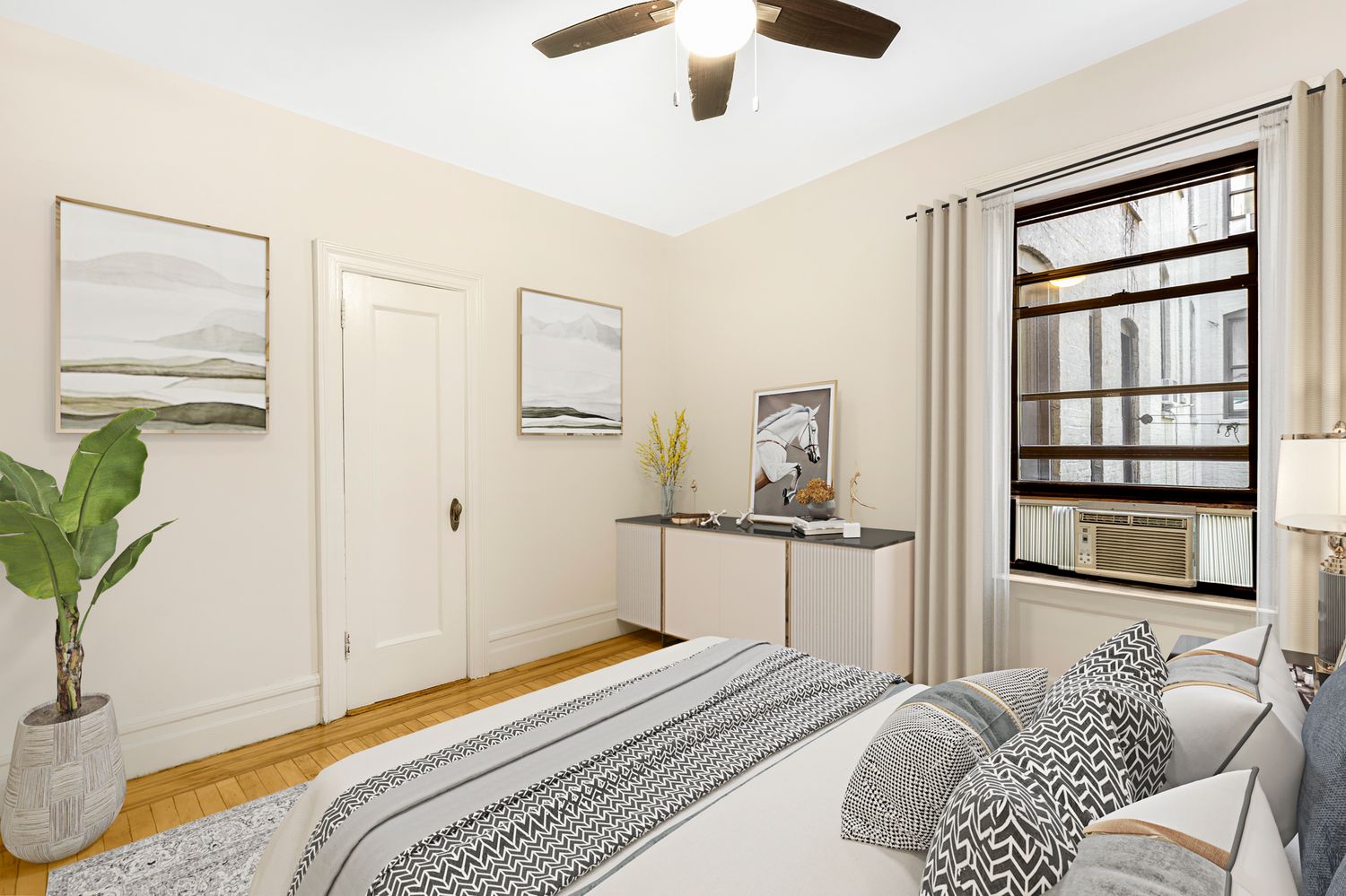 a bedroom with a bed and a potted plant