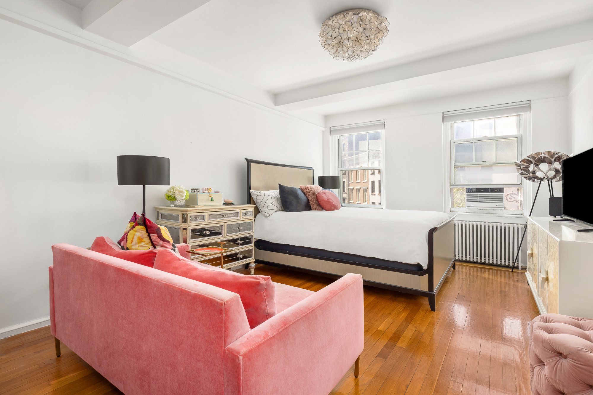 45 Christopher Street, Unit 3C Manhattan, NY 10014 - Photo 7 of 11 a bedroom with furniture and a wooden floor