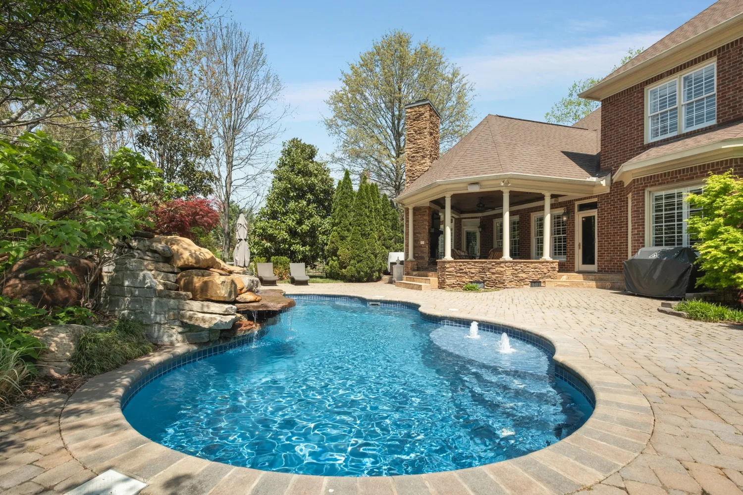 a view of a house with swimming pool and porch