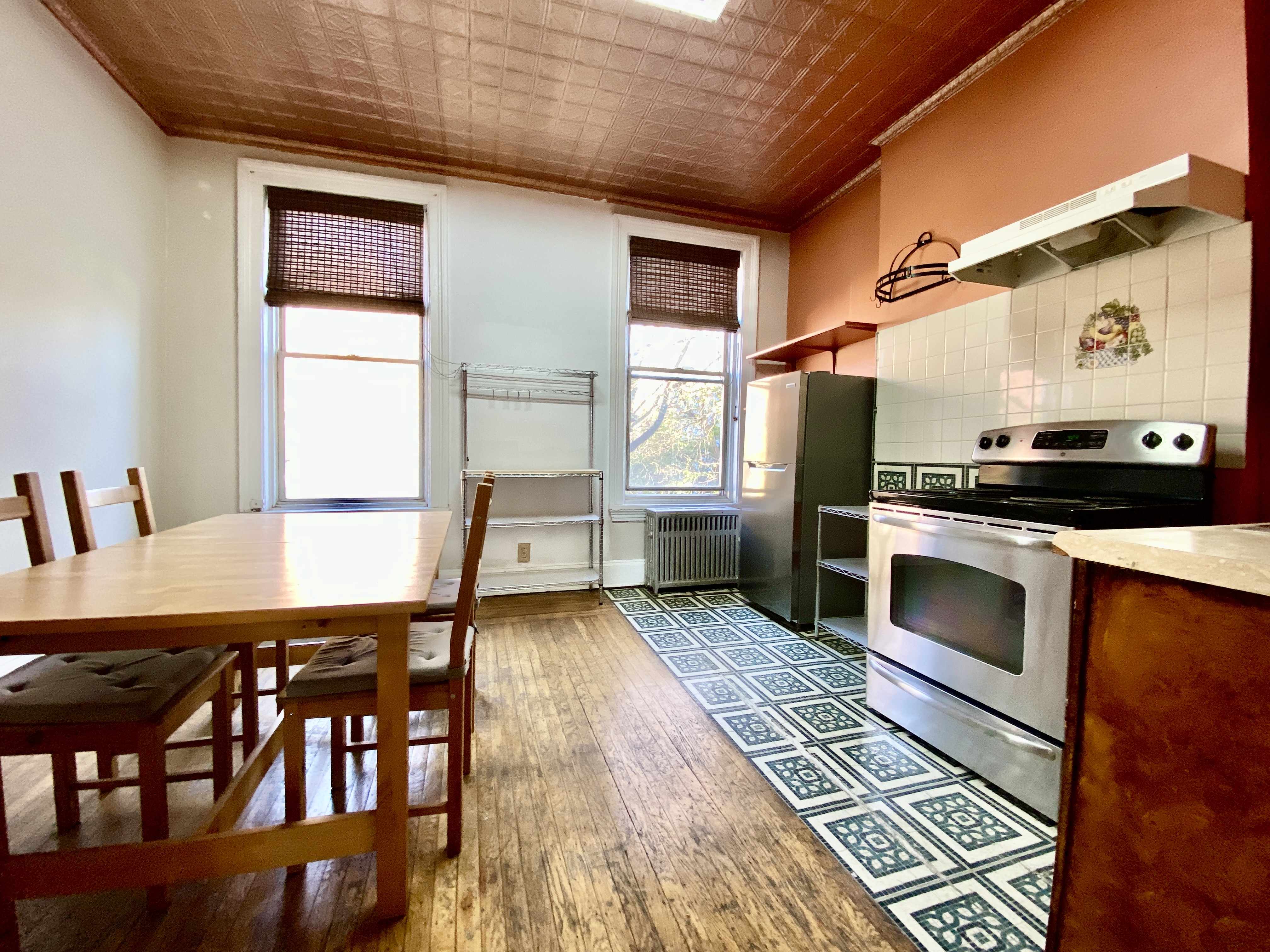 699 4th Avenue, Unit 3 Brooklyn, NY 11232 - Photo 5 of 8 a kitchen with stainless steel appliances granite countertop a stove a sink and a refrigerator