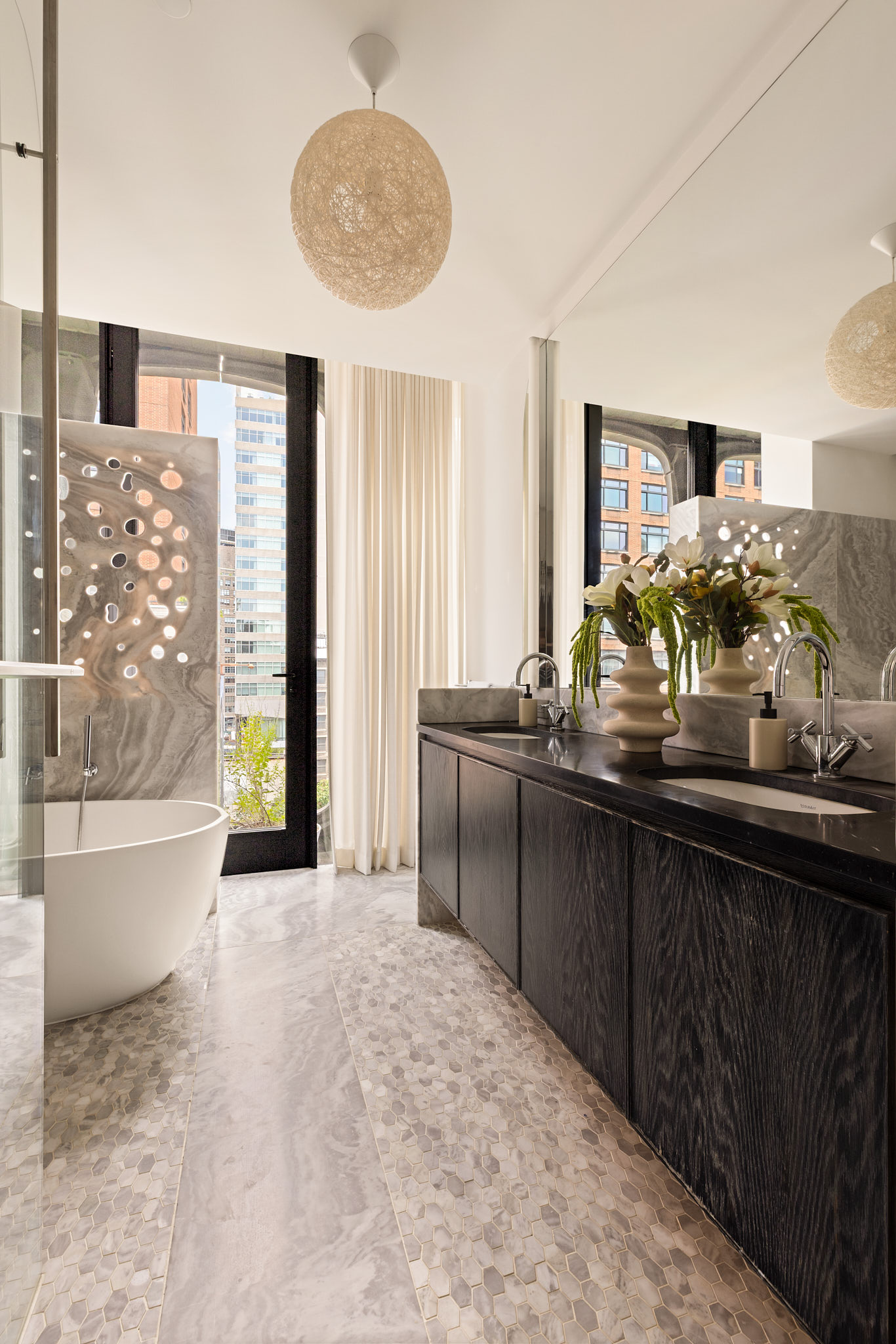 325 West Broadway, Unit 7B Manhattan, NY 10013 - Photo 8 of 21 a bathroom with a double vanity sink a large mirror and bathtub