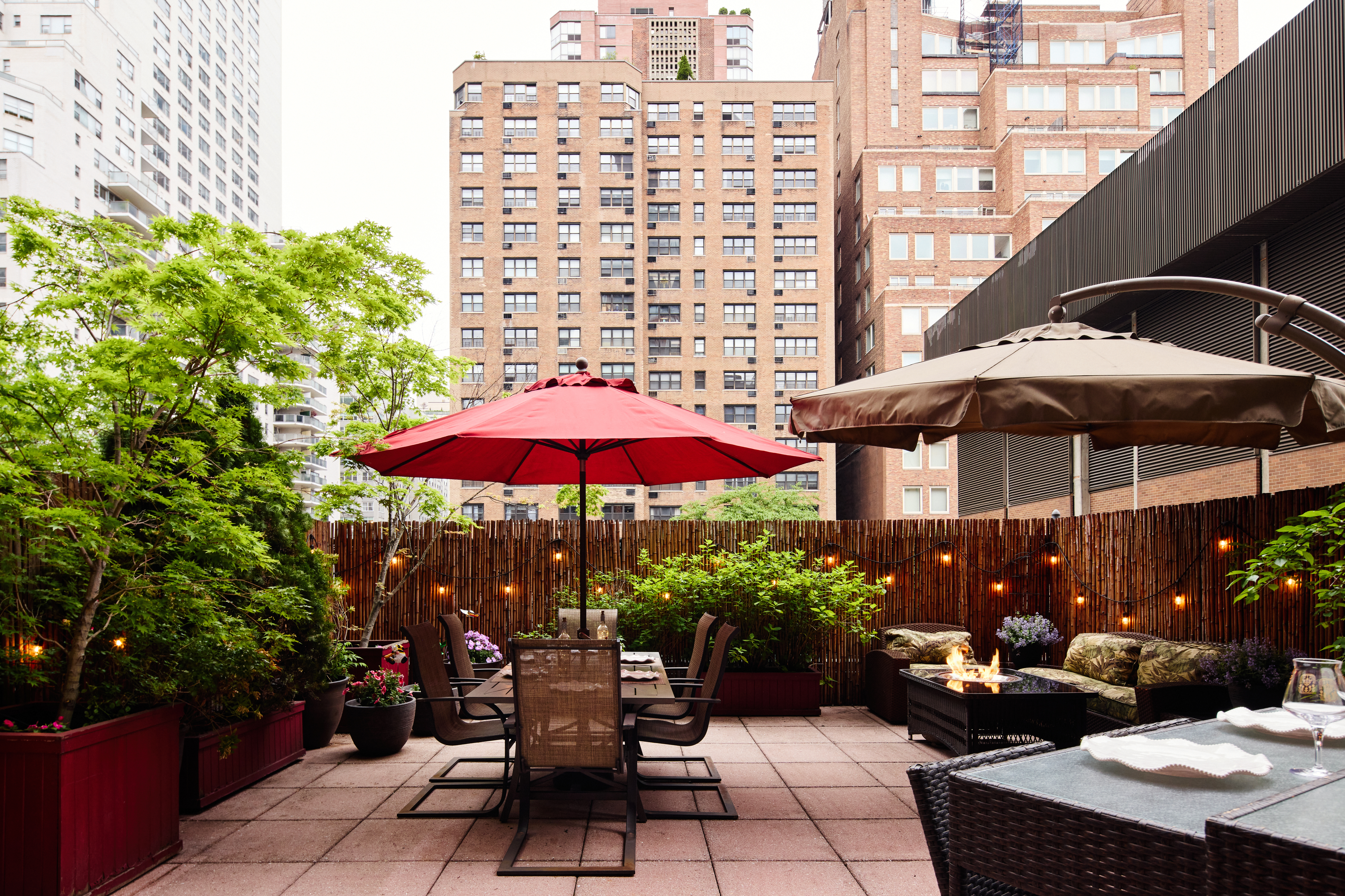 301 East 62nd Street, Unit 2K Manhattan, NY 10065 - Photo 6 of 9 a view of a patio with a table and chairs under an umbrella