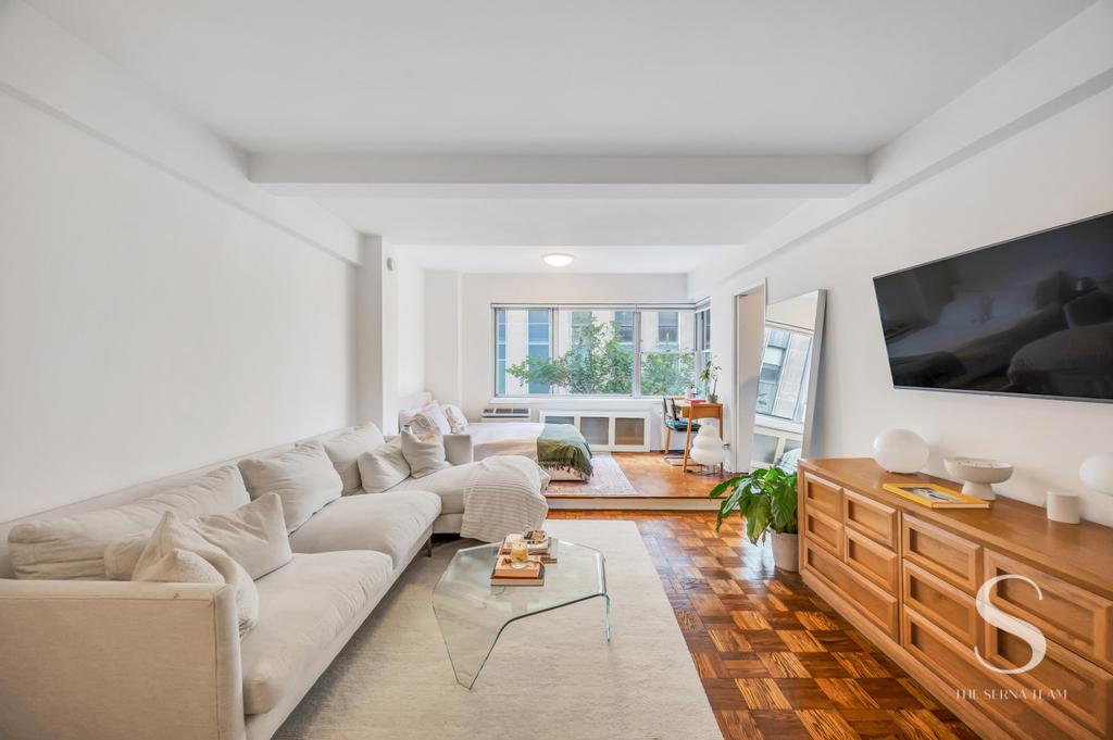 7 Lexington Avenue, Unit 5E Manhattan, NY 10010 - Photo 2 of 27 a living room with furniture and a flat screen tv