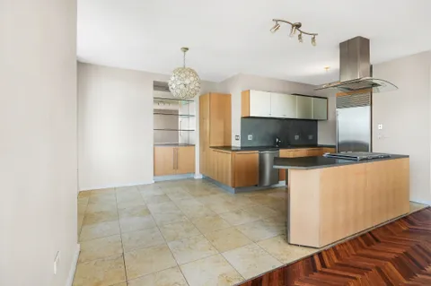 a kitchen with kitchen island cabinets and appliances