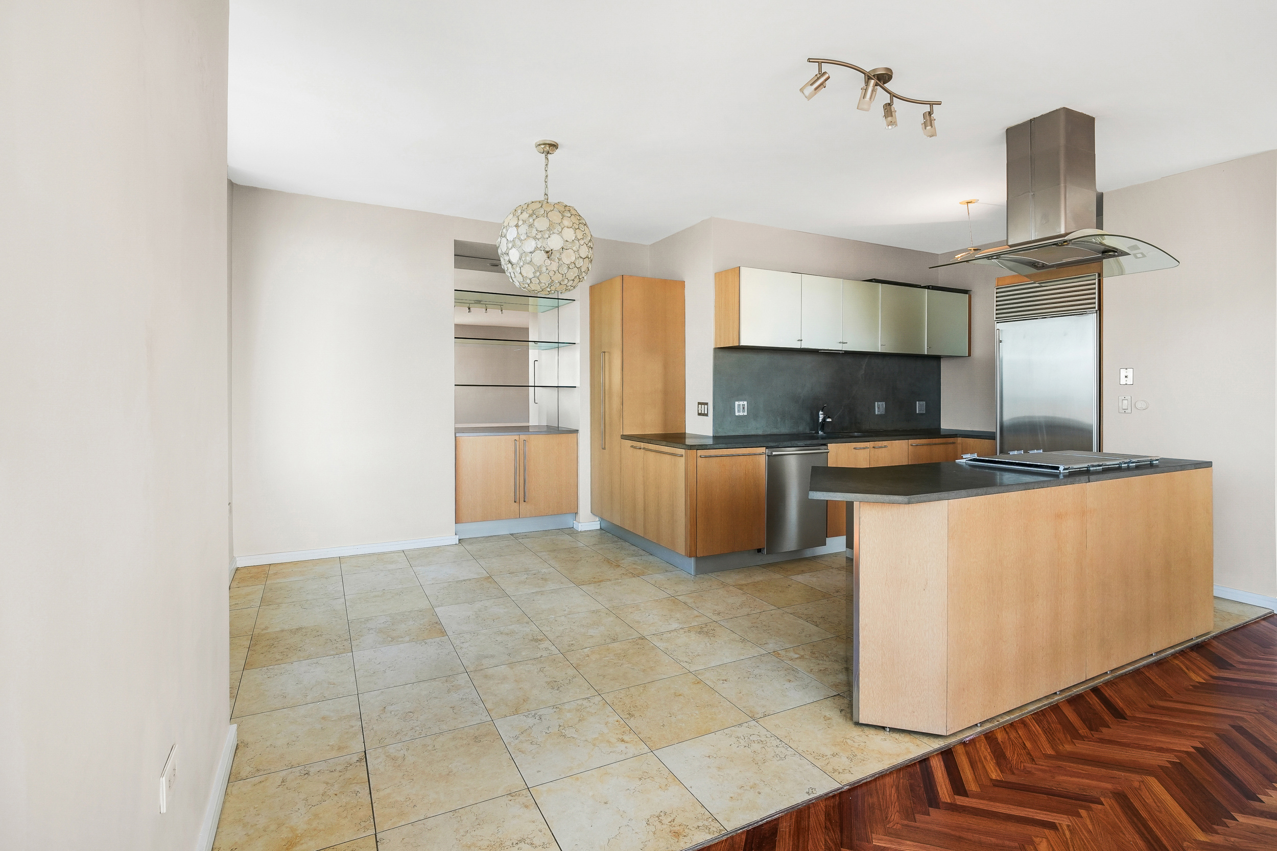 360 East 88th Street, Unit 34A Manhattan, NY 10128 - Photo 9 of 35 a kitchen with kitchen island cabinets and appliances