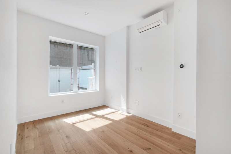 100 2nd Avenue, Unit 2 Manhattan, NY 10003 - Photo 7 of 10 a view of empty room with wooden floor and fan