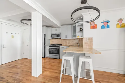 a kitchen with stainless steel appliances a stove a refrigerator and a microwave