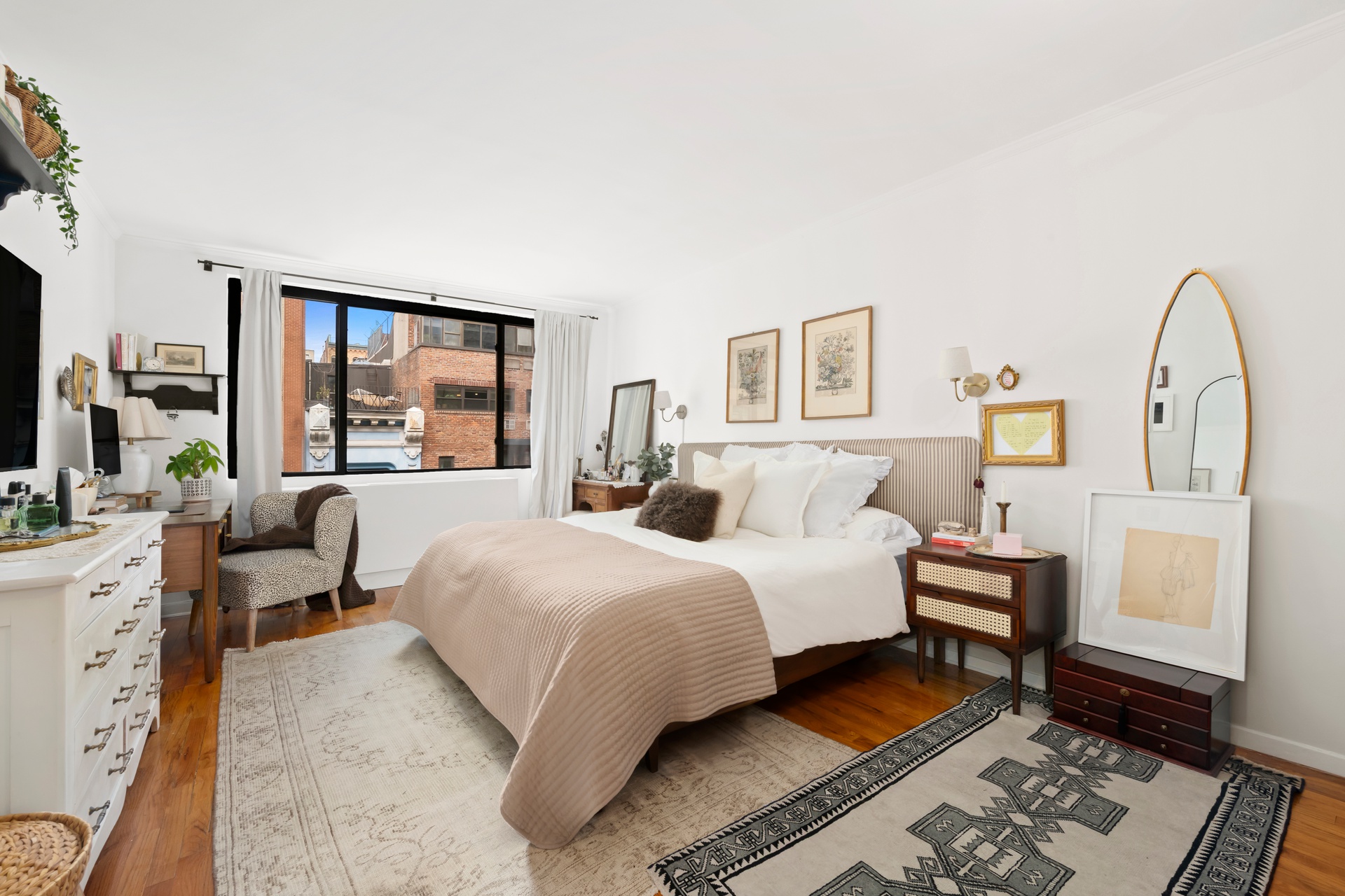 44 East 12th Street, Unit 7E Manhattan, NY 10003 - Photo 4 of 6 a bedroom with a bed and a large window