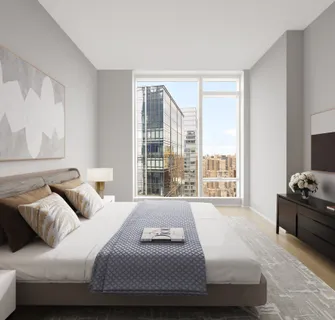 a bedroom with a bed and glass window