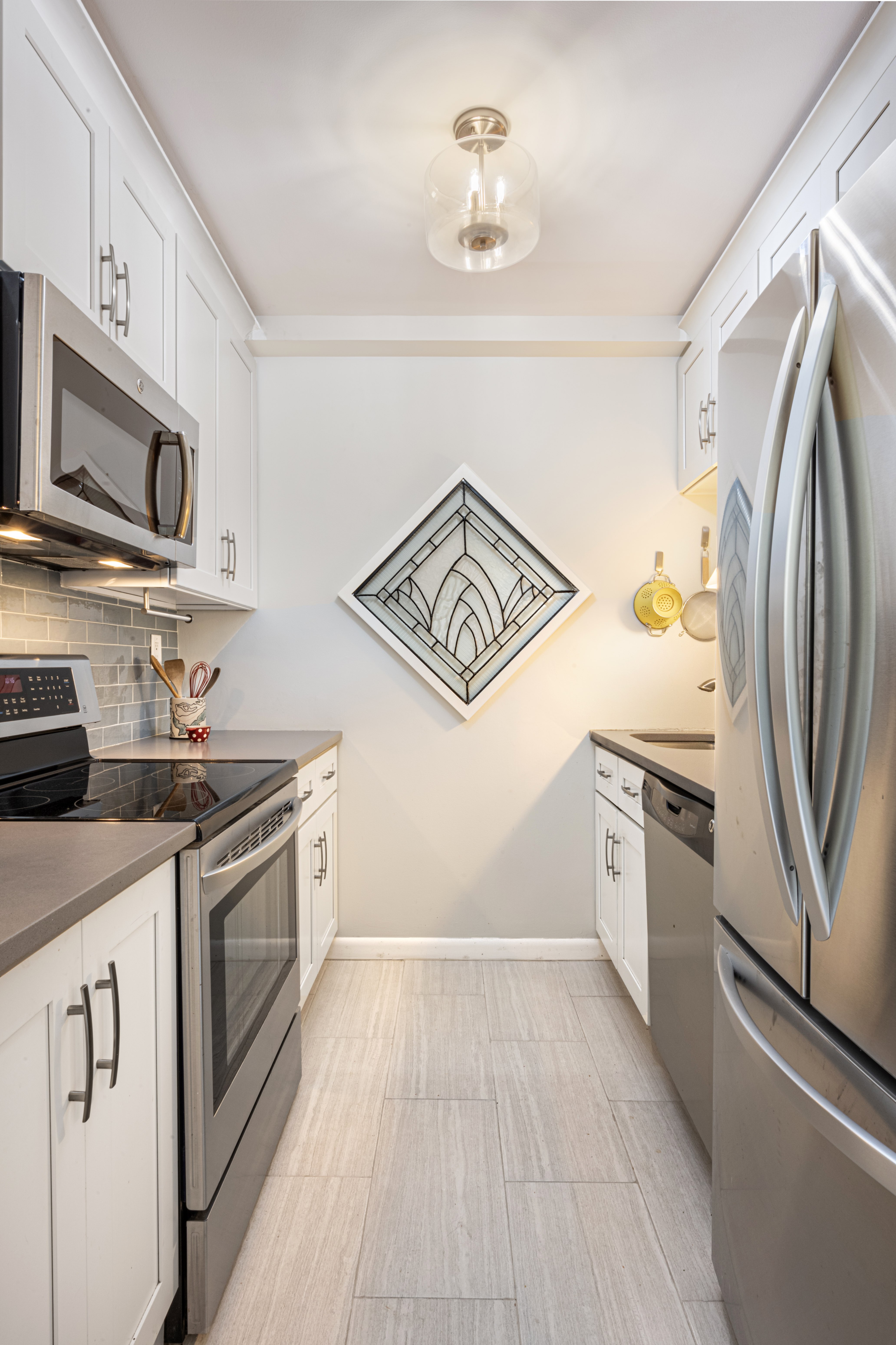 45 Overlook Terrace, Unit 4E Manhattan, NY 10033 - Photo 2 of 17 a kitchen with stainless steel appliances granite countertop a stove and a refrigerator