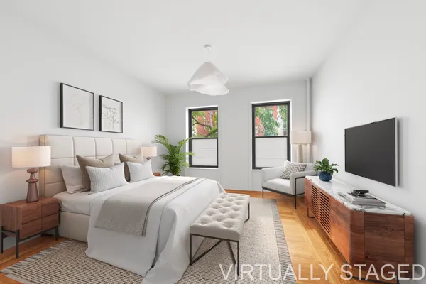 a bedroom with a bed and a flat screen tv