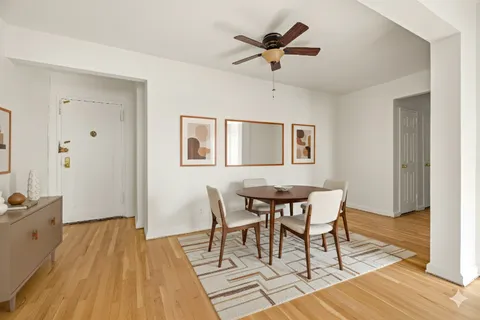 a view of a dining room with furniture and wooden floor