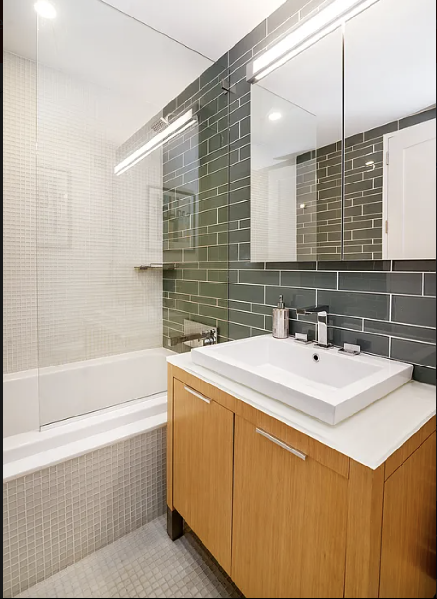 34 North 7th Street, Unit 7E Brooklyn, NY 11249 - Photo 5 of 20 a bathroom with a sink a bathtub a mirror a vanity and a shower