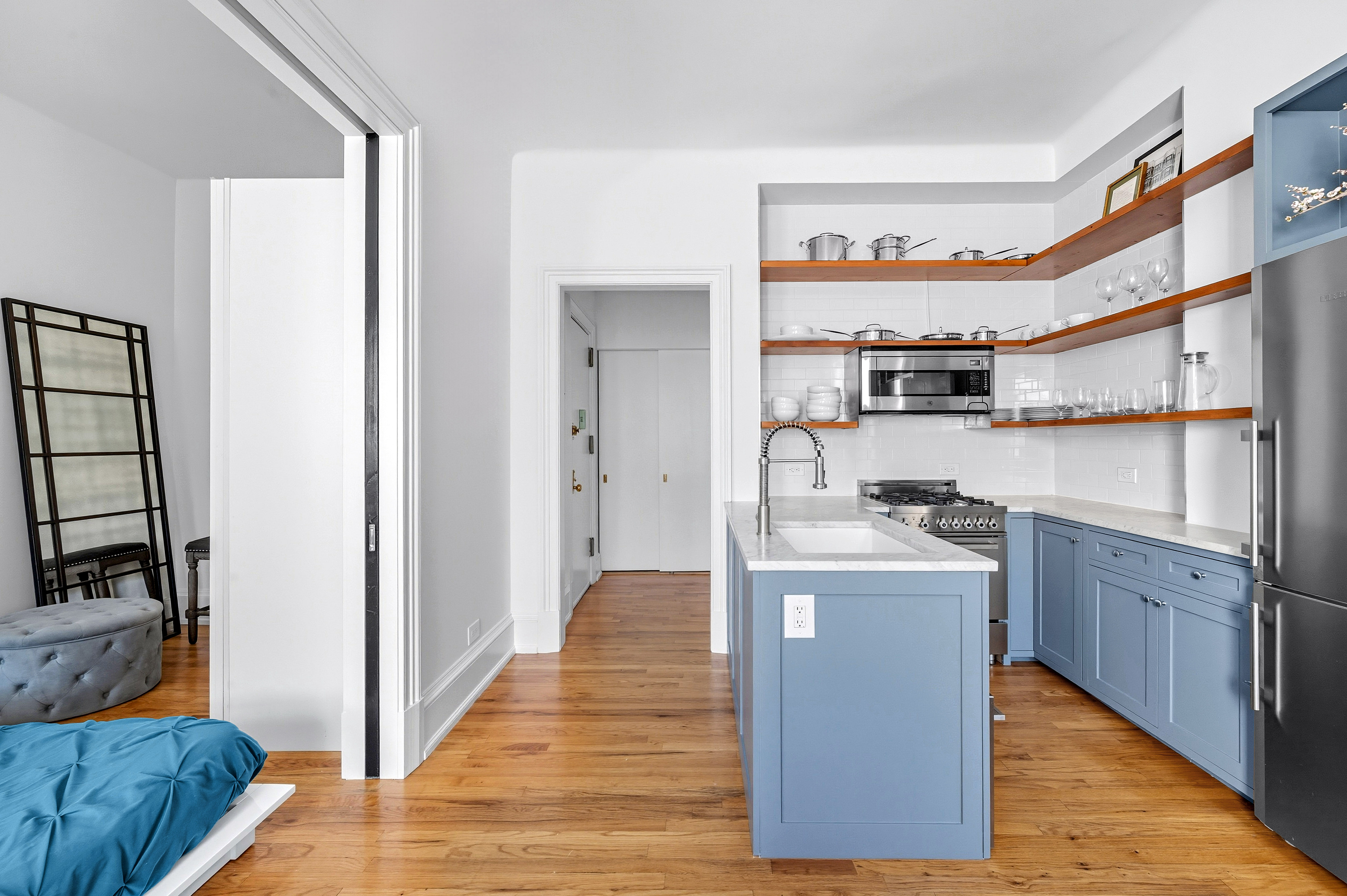 308 West 106th Street, Unit 4R Manhattan, NY 10025 - Photo 3 of 10 a living room with stainless steel appliances granite countertop furniture wooden floor and a window