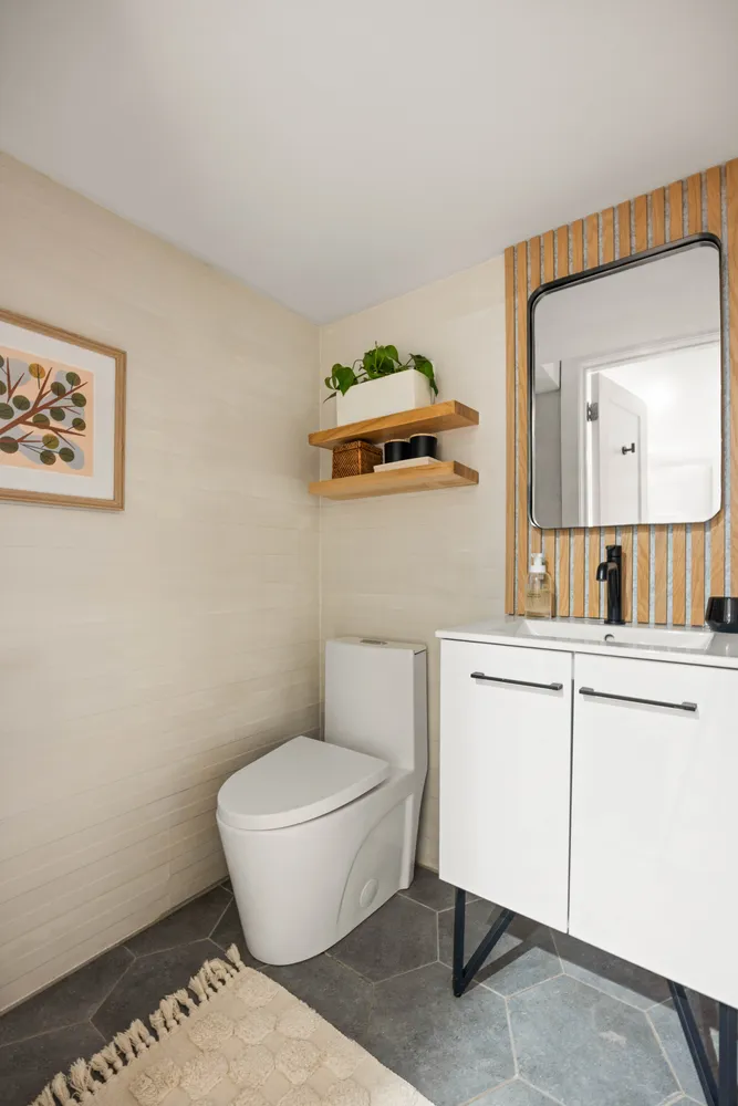 a bathroom with a toilet a sink and mirror