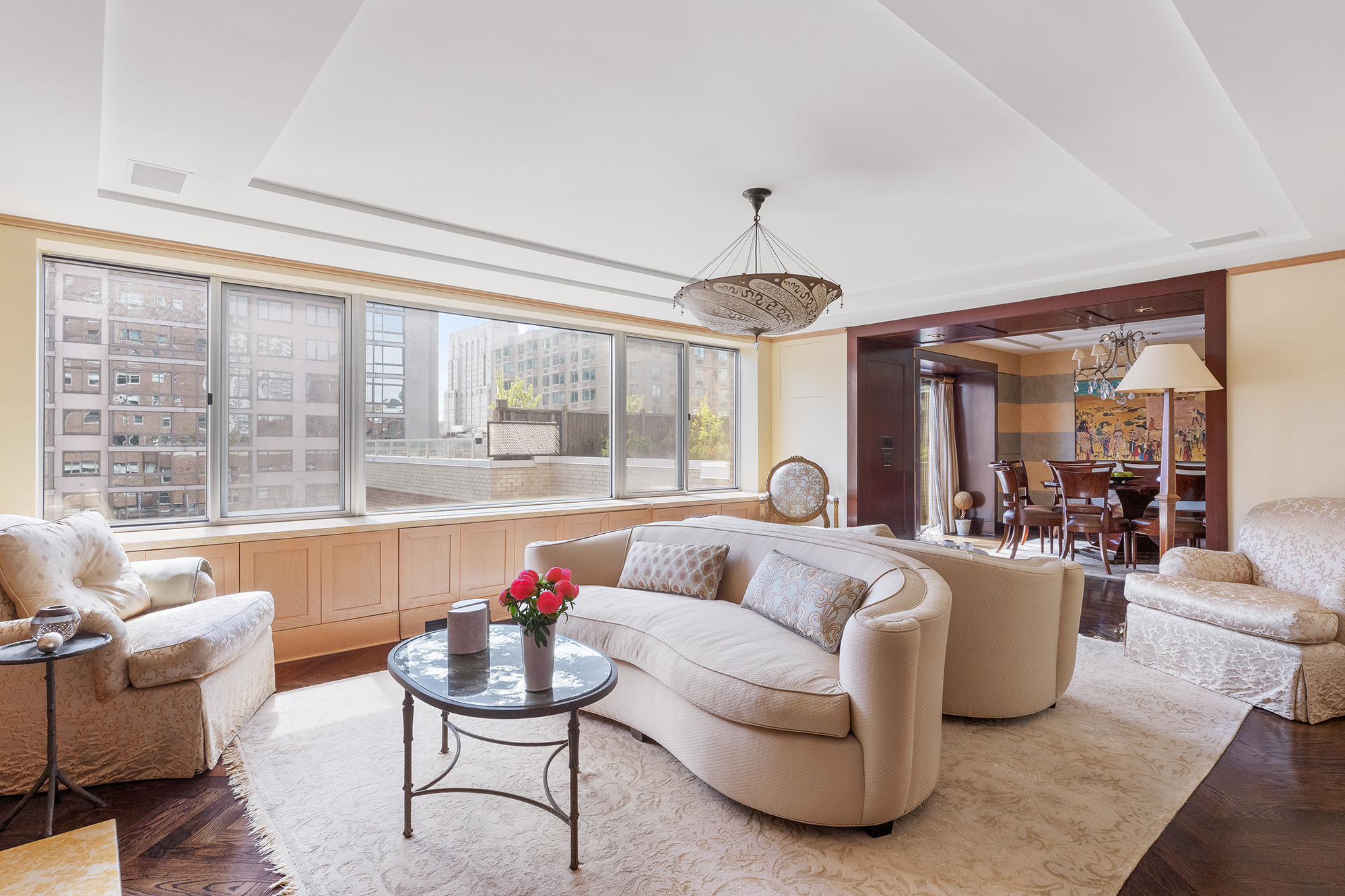 360 East 72nd Street, Unit C1801 Manhattan, NY 10021 - Photo 2 of 20 a living room with furniture and a large window