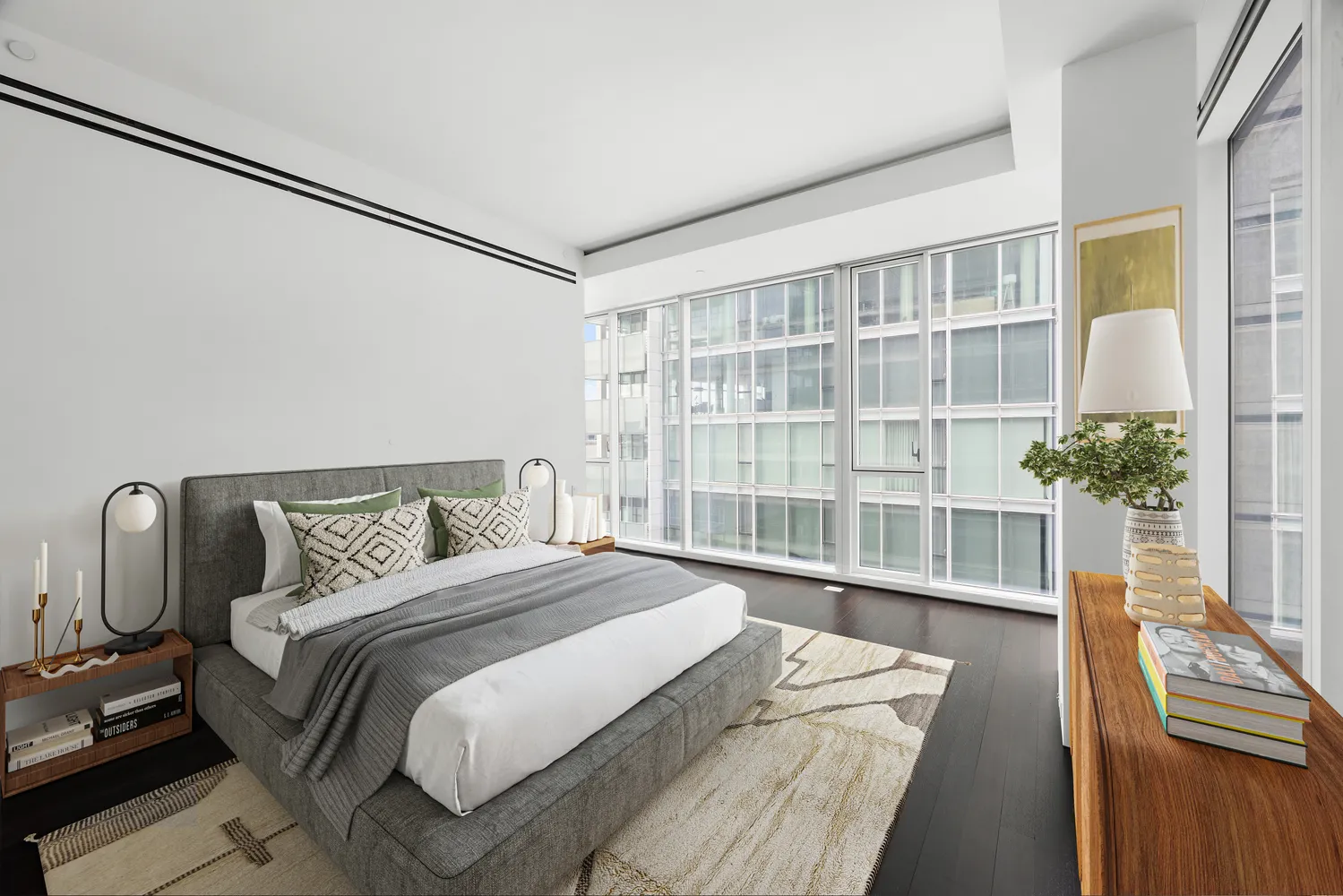 a bedroom with a bed and a potted plant