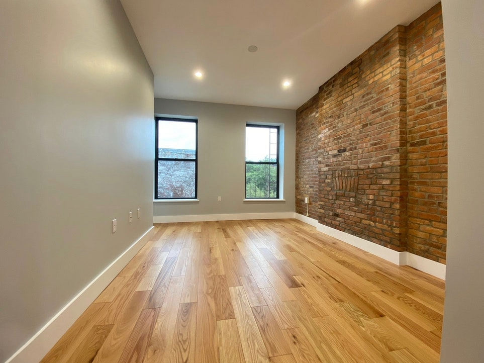 465 6th Avenue, Unit 2 Brooklyn, NY 11215 - Photo 4 of 10 wooden floor in an empty room with a window