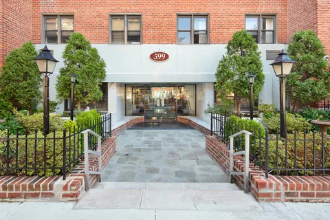 a front view of a building with a garden