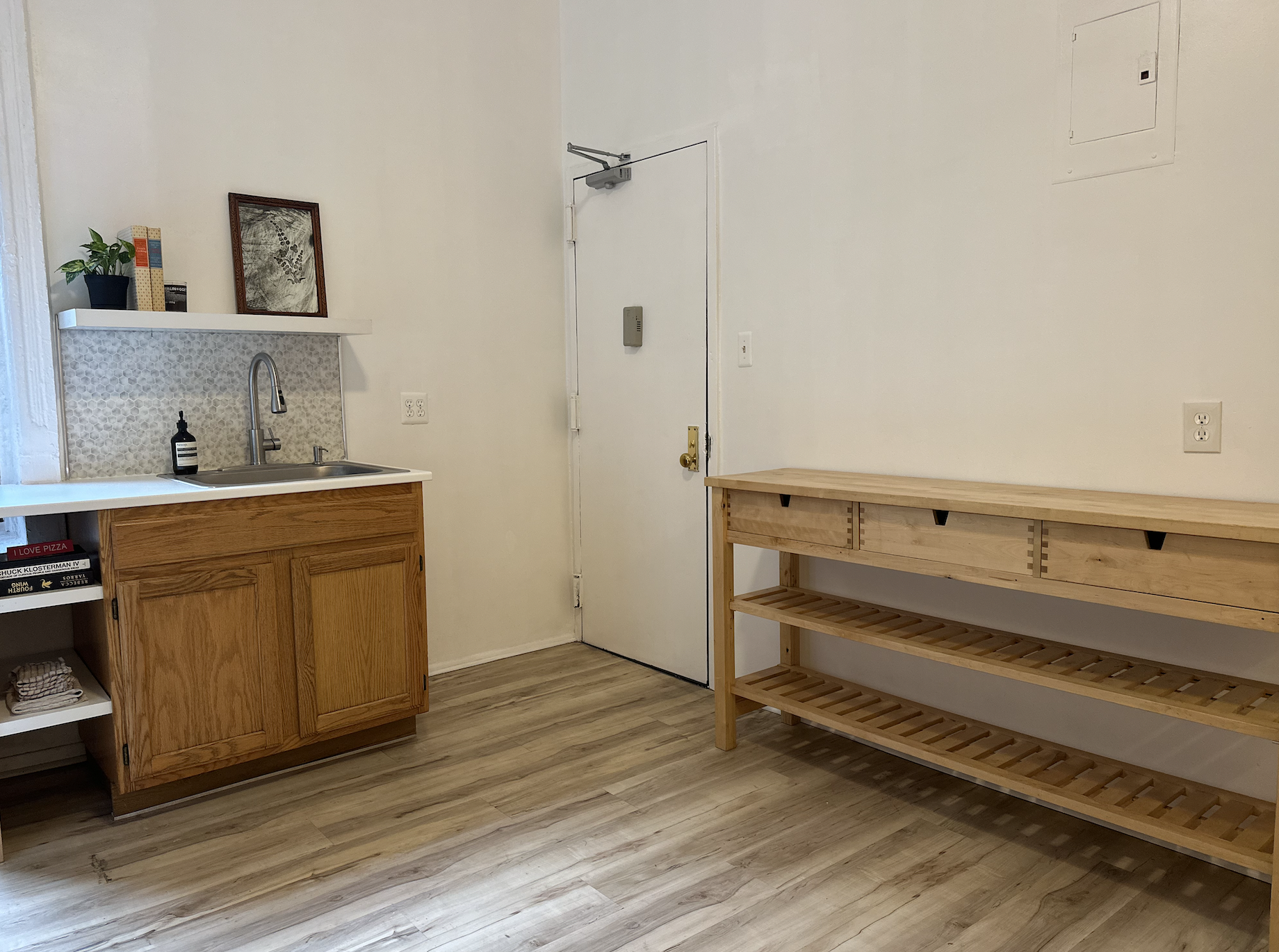 458 West 57th Street, Unit 5FE Manhattan, NY 10019 - Photo 2 of 14 a room with a bench and cabinets
