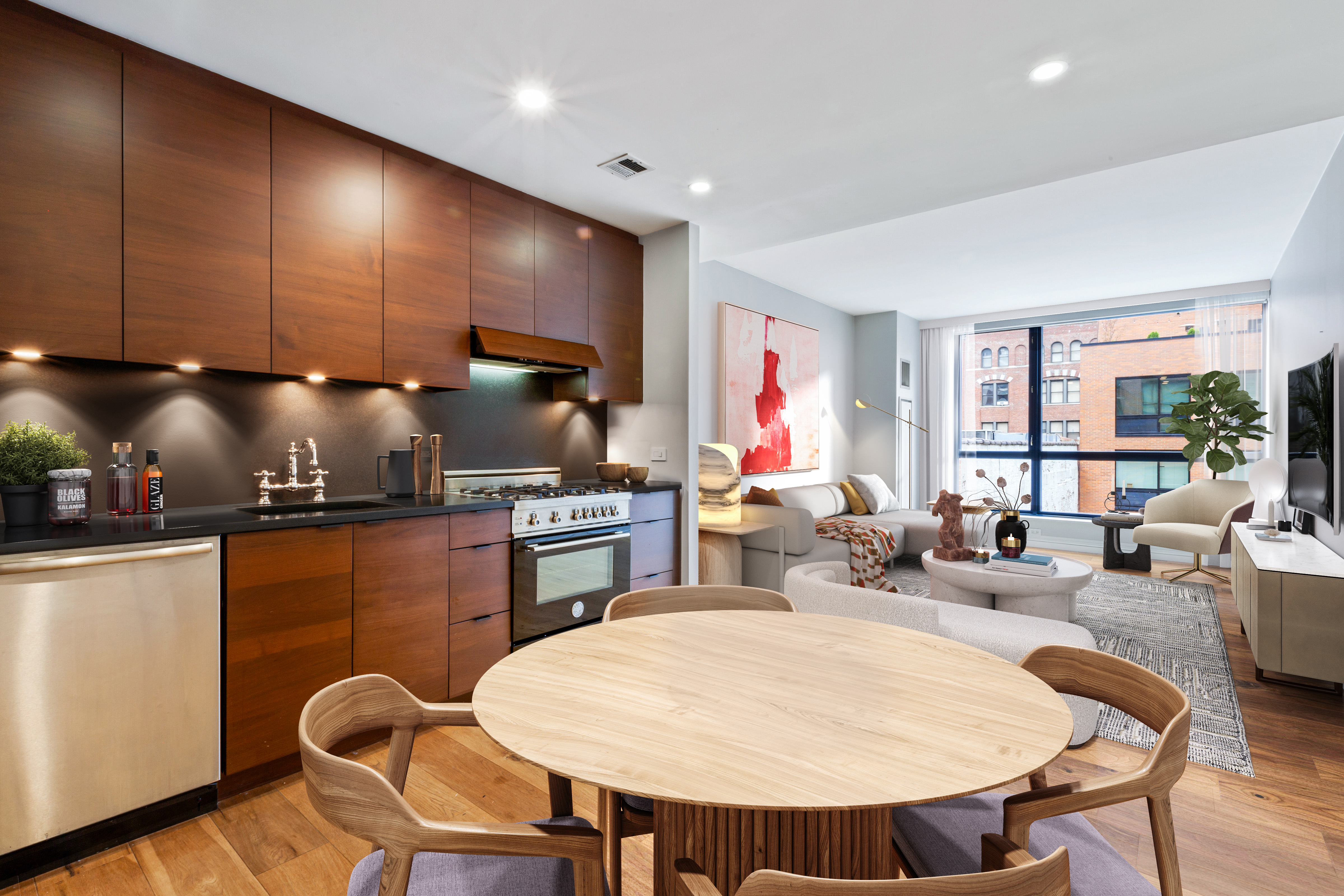 540 West 28th Street, Unit 4F Manhattan, NY 10001 - Photo 1 of 16 a kitchen with stainless steel appliances kitchen island granite countertop a sink a stove a dining table and chairs