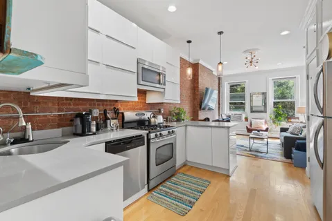 a kitchen with a sink a stove and cabinets