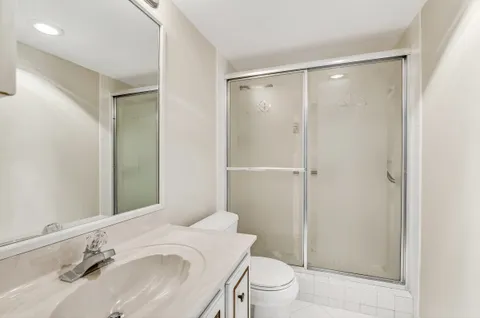 a bathroom with a sink toilet and shower
