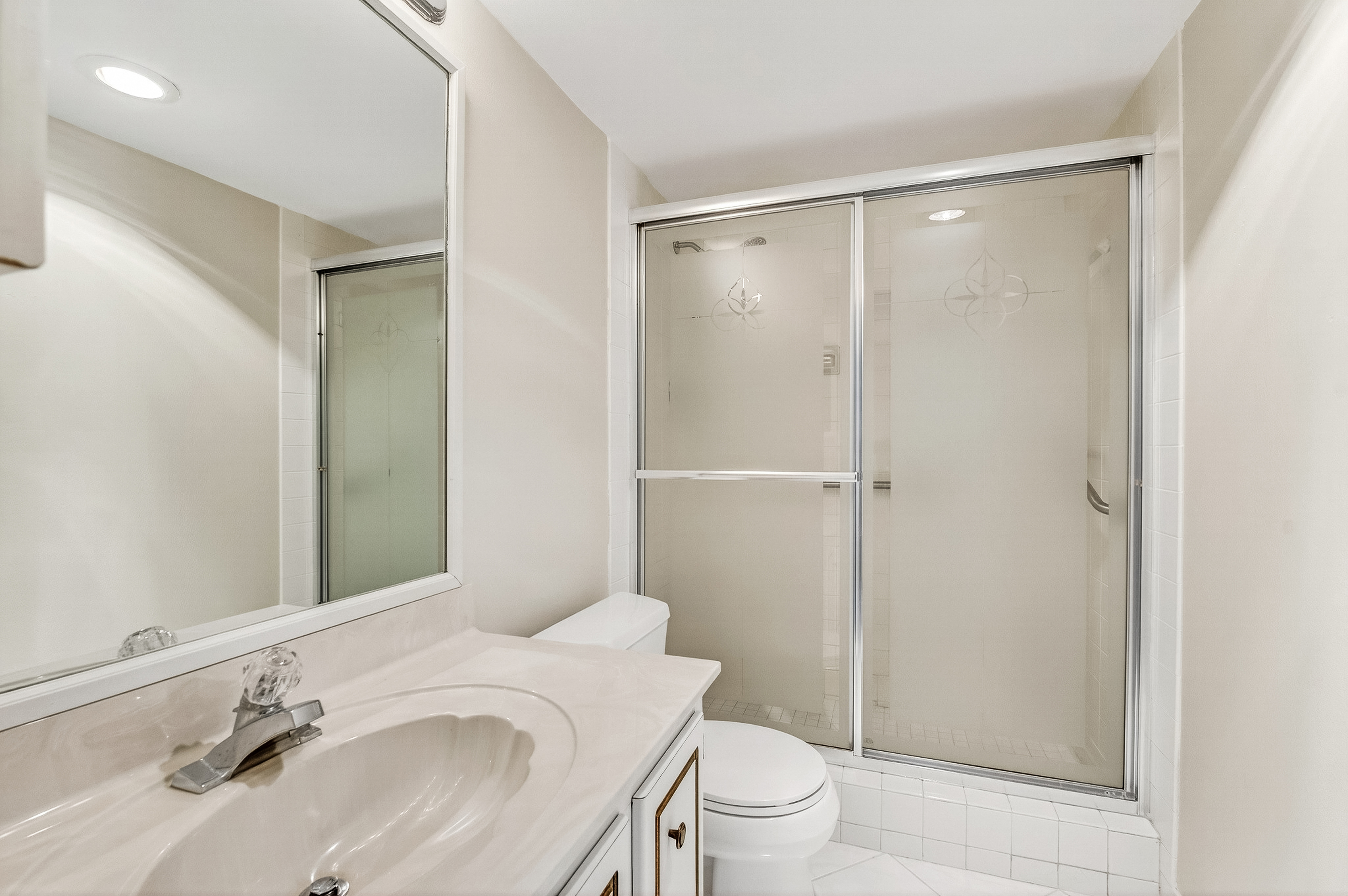4601 Highway A1a, Unit 102 Vero Beach, FL 32963 - Photo 12 of 29 a bathroom with a sink toilet and shower