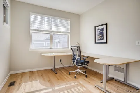 a view of a workspace with furniture and a window