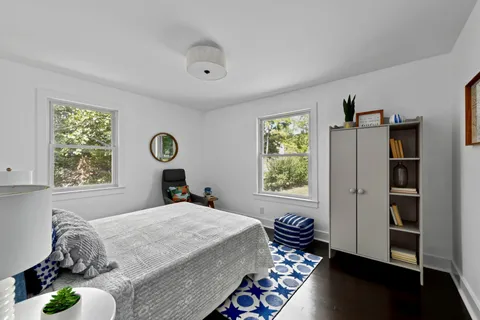 a bathroom with a granite countertop sink a toilet and mirror