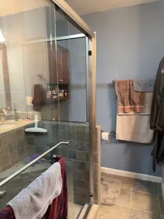 a bathroom with a bathtub and shower