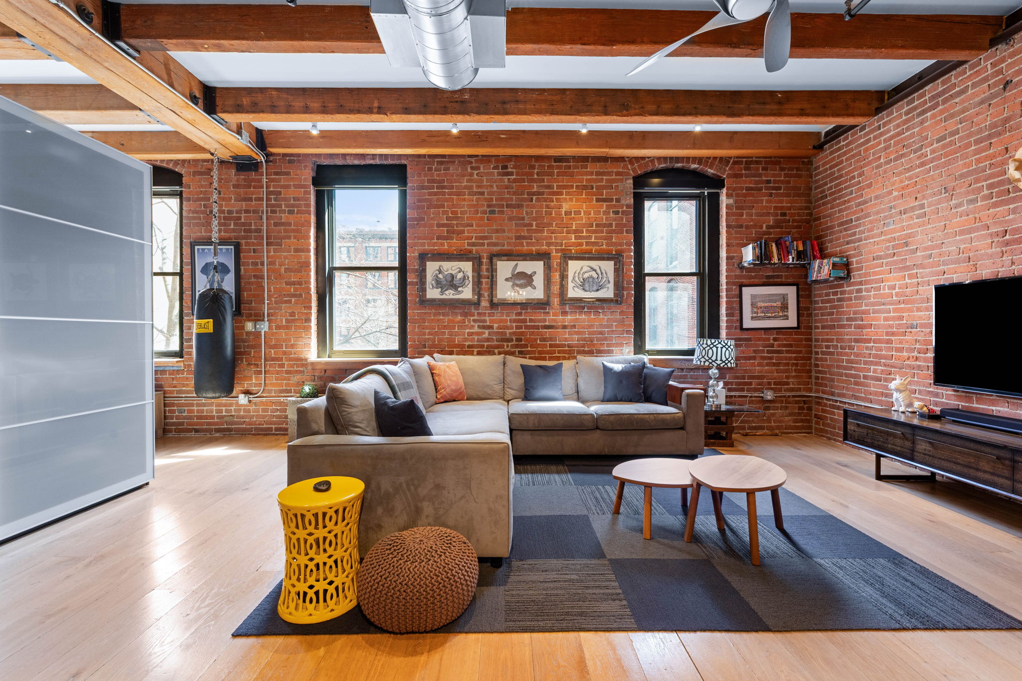 33 Sleeper Street, Unit 307 Boston, MA 02210 - Photo 7 of 15 a living room with furniture and a flat screen tv