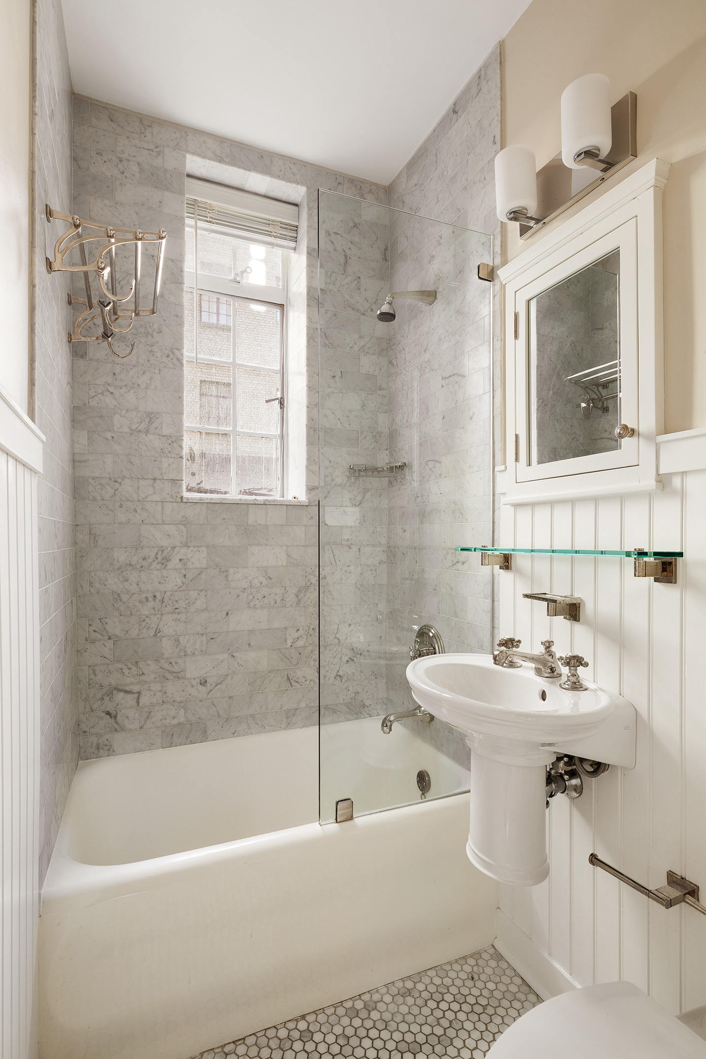 115 East 67th Street, Unit 3C Manhattan, NY 10065 - Photo 16 of 21 a white bath tub sitting next to a white sink
