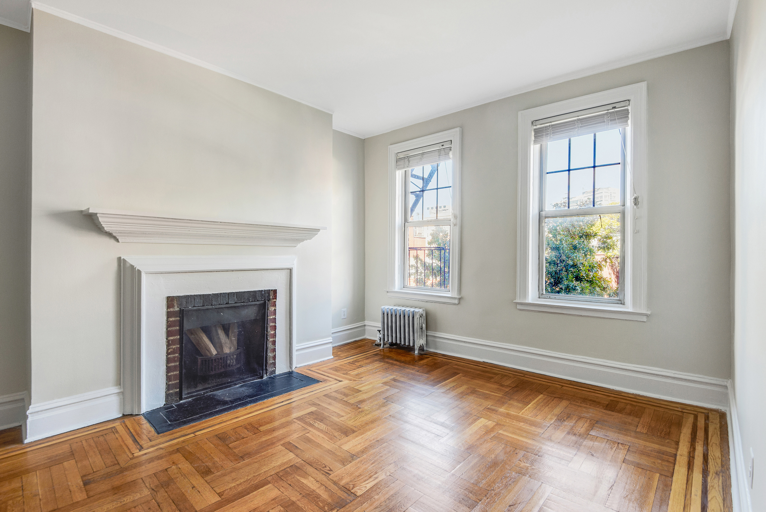 344 West 12th Street, Unit 5C Manhattan, NY 10014 - Photo 1 of 11 a view of an empty room with window and fire place