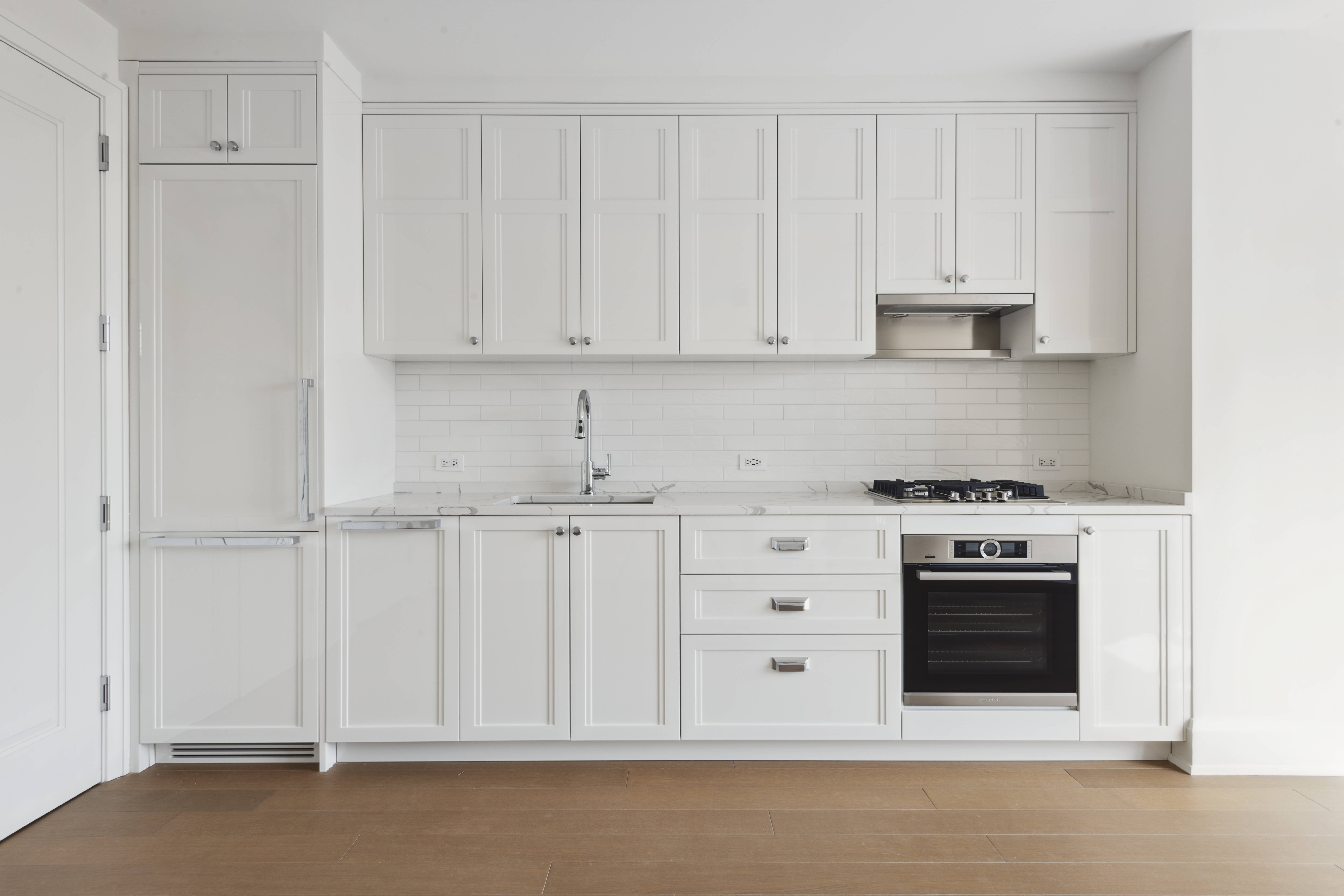 100 Claremont Avenue, Unit 10D Manhattan, NY 10027 - Photo 5 of 11 a kitchen with white cabinets and white appliances