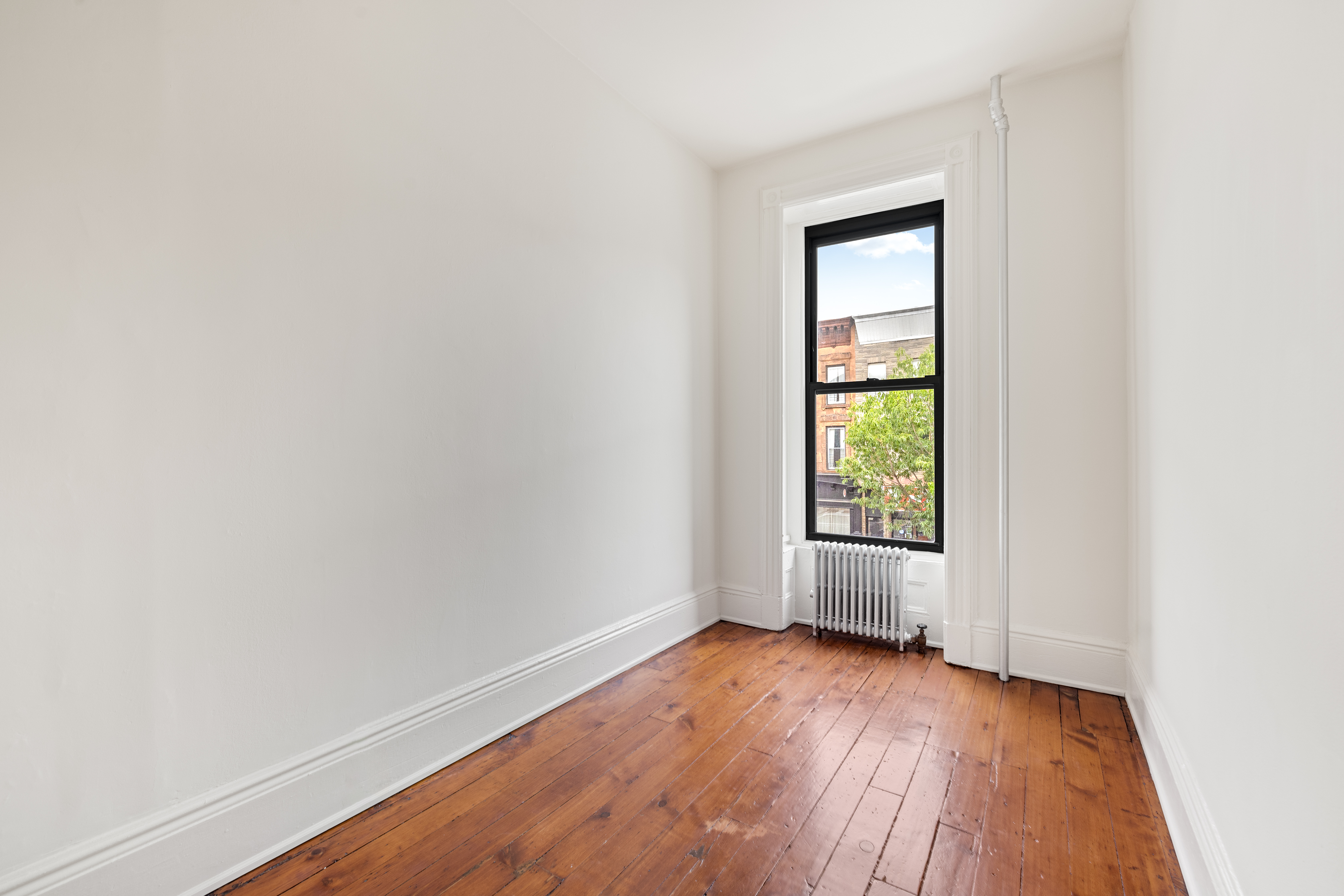 353 7th Avenue, Unit 1 Brooklyn, NY 11215 - Photo 3 of 8 an empty room with wooden floor and windows