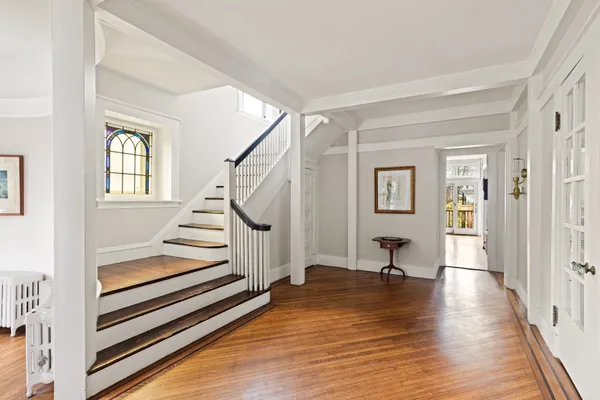 a view of an entryway with wooden floor and windows
