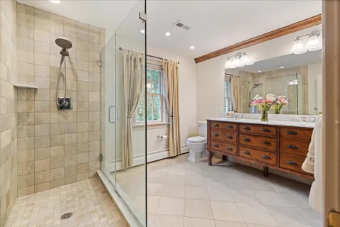 a bathroom with a sink a toilet and shower curtain