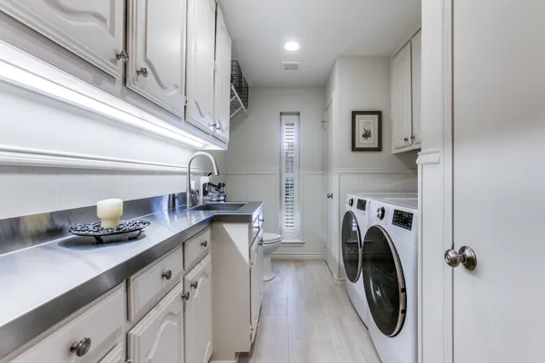 a spacious bathroom with double sink and a mirror