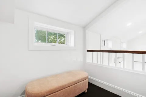 a bathroom with a toilet and a window