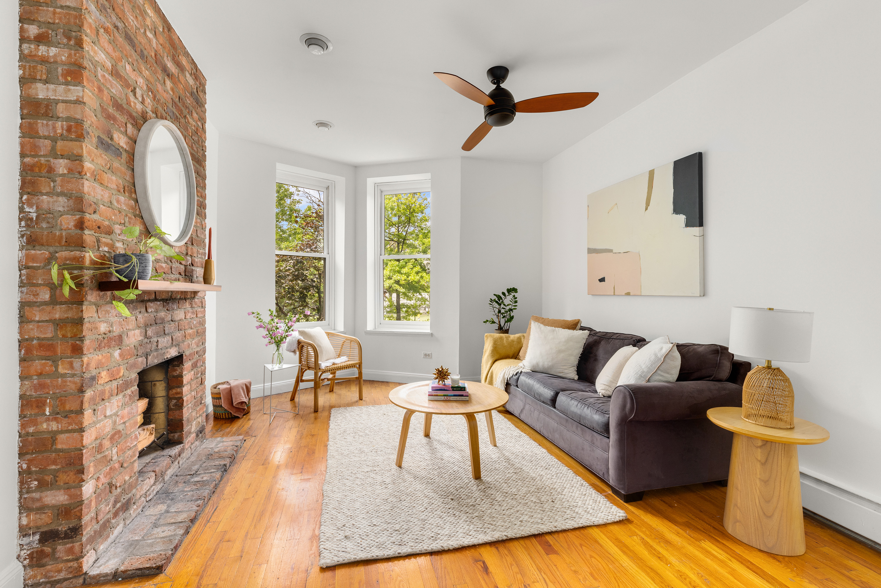 a living room with fireplace furniture and a wooden floor