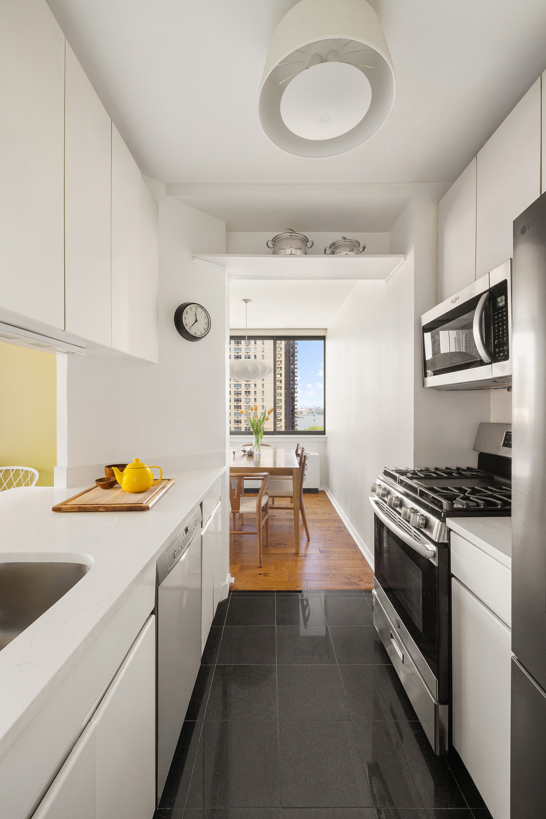 455 East 86th Street, Unit 11A Manhattan, NY 10028 - Photo 4 of 11 a kitchen with stainless steel appliances granite countertop a stove and a sink