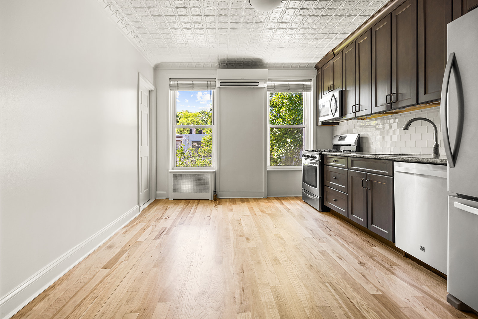 616 Carroll Street, Unit 2 Brooklyn, NY 11215 - Photo 9 of 15 a kitchen with stainless steel appliances granite countertop a stove a sink dishwasher and a refrigerator with wooden floor