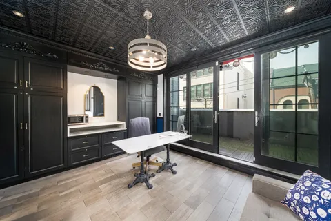 a view of a room with a table and chairs