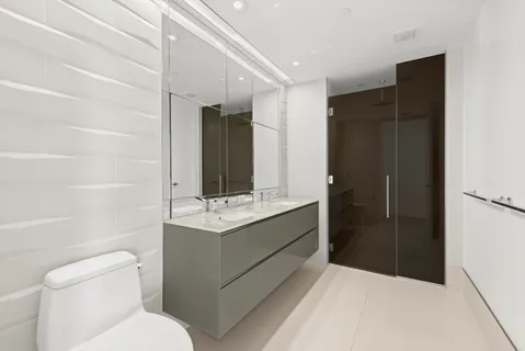 a bathroom with a toilet sink and shower