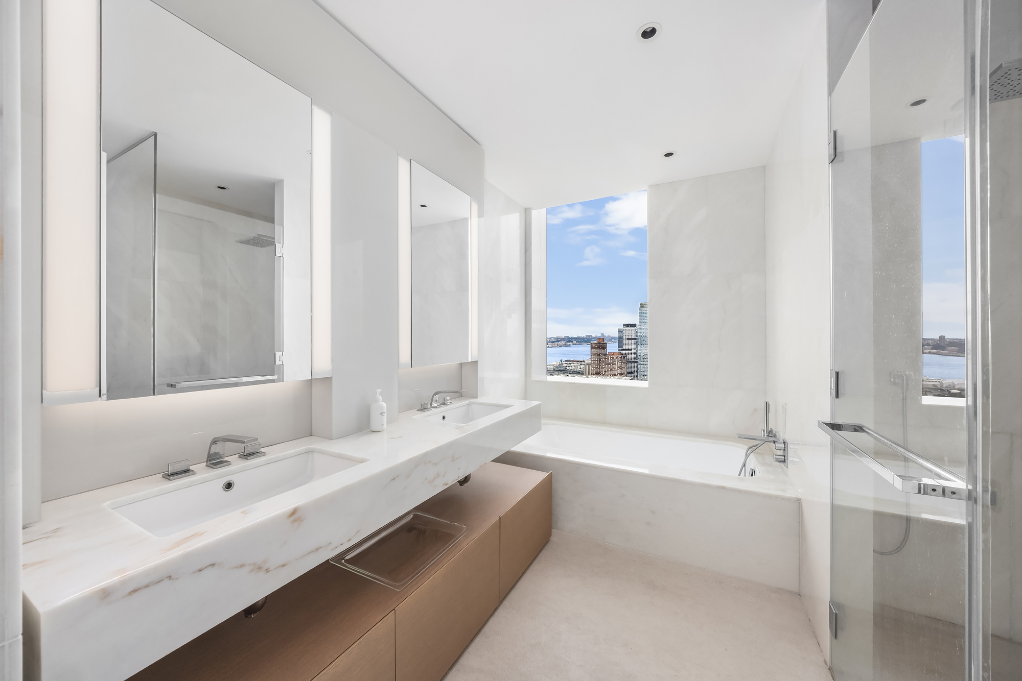 15 Hudson Yards, Unit 37G Manhattan, NY 10001 - Photo 7 of 24 a bathroom with a tub sink double and mirror